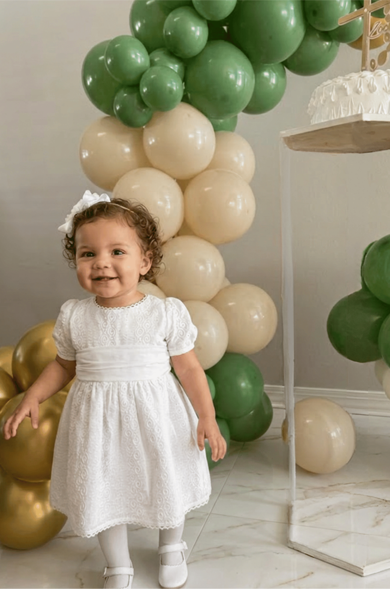 A toddler girl wearing The Petite Lumière white embroidered puffed sleeve dress-Alfa Baby Boutique.