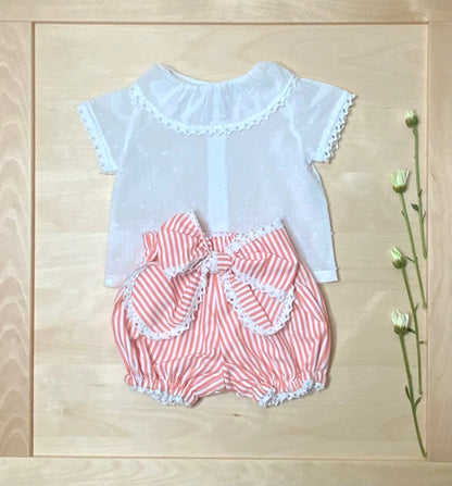The Coral white plumeti blouse and coral striped bubble shorts set on light wood background — Alfa Baby Boutique