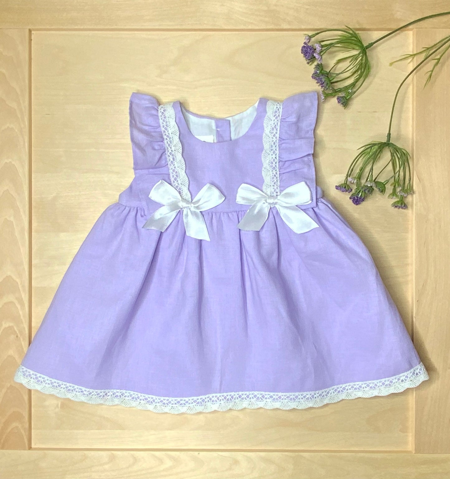 The Violet lavender dress on light wood background— Alfa Baby Boutique