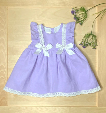 The Violet lavender dress on light wood background— Alfa Baby Boutique