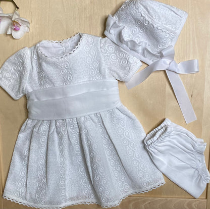 The Petite Lumière white embroidered dress and bloomers set on light wood background — Alfa Baby Boutique