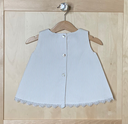 Back view of The Sweet Vanilla ivory striped A-line dress showing button closure and lace hem trim — Alfa Baby Boutique